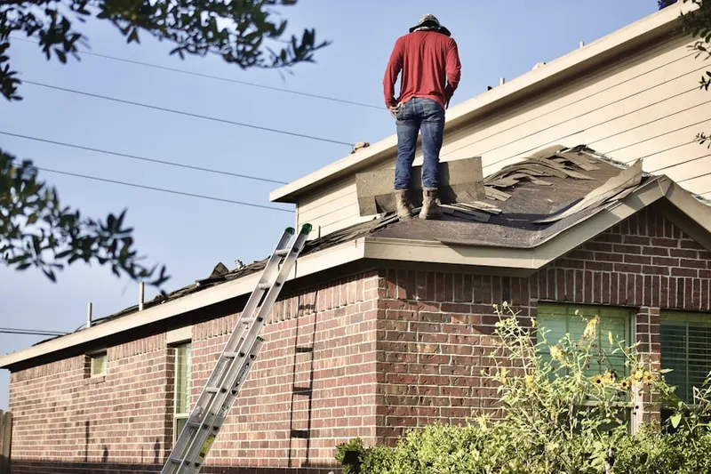 Professional roofer working on a residential roof in Adamsville